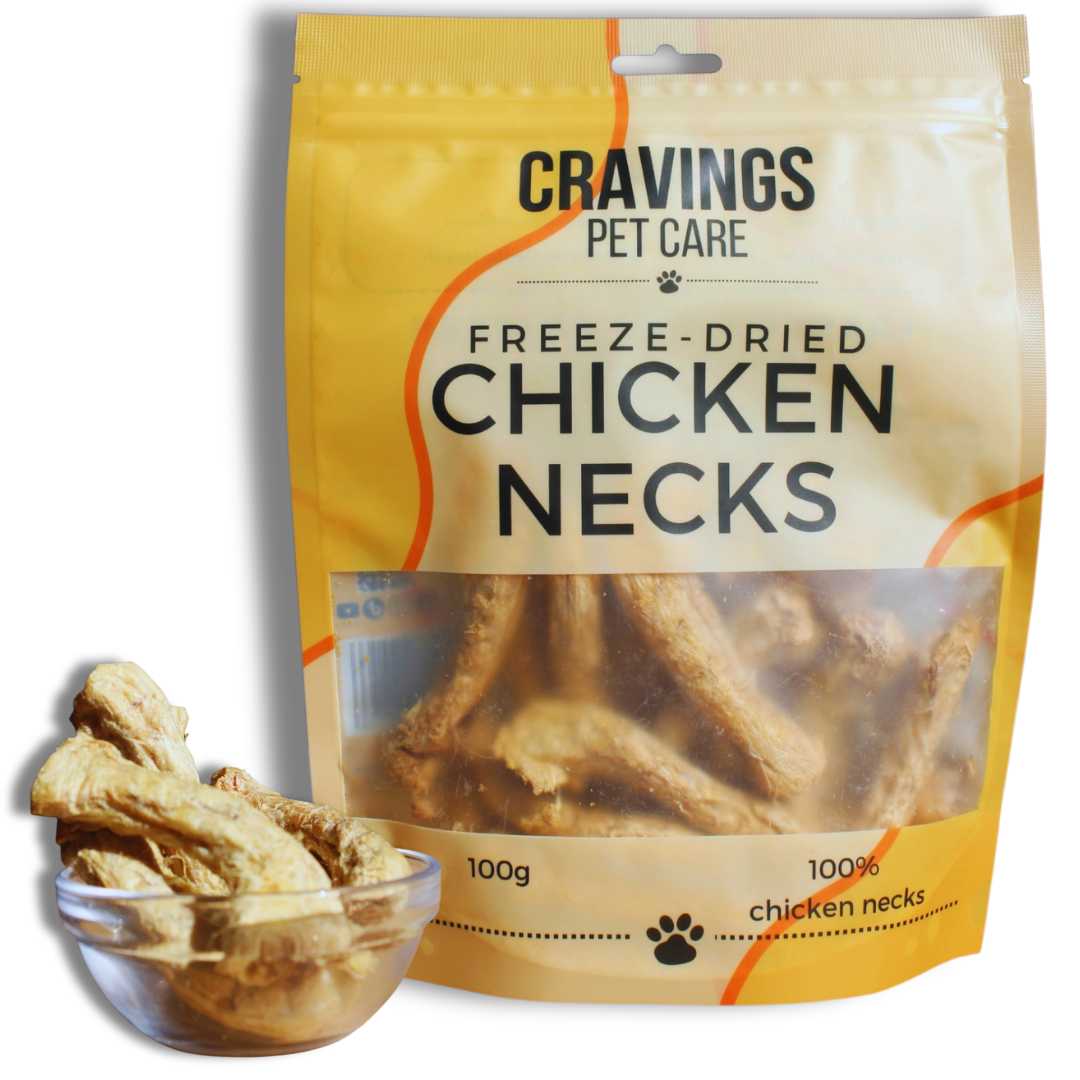 A yellow and cream Cravings Pet Care Freeze-Dried Chicken Necks 100g pouch beside a glass bowl of pale chicken necks on a white background.